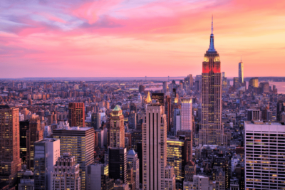 Image of New York City with Empire State building at sunset.